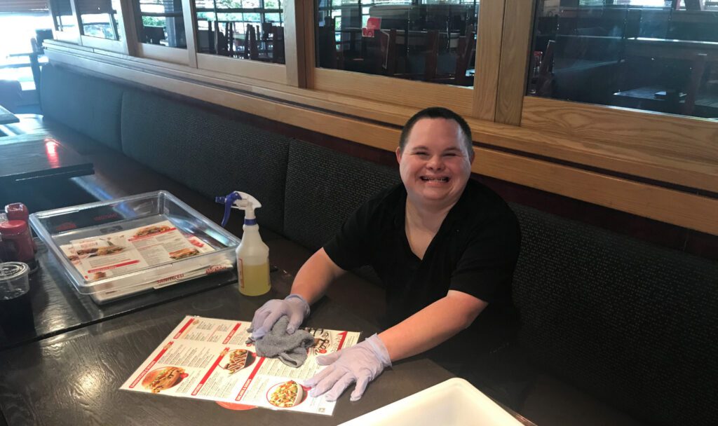 Brandon Golonka smiles while working at red robin