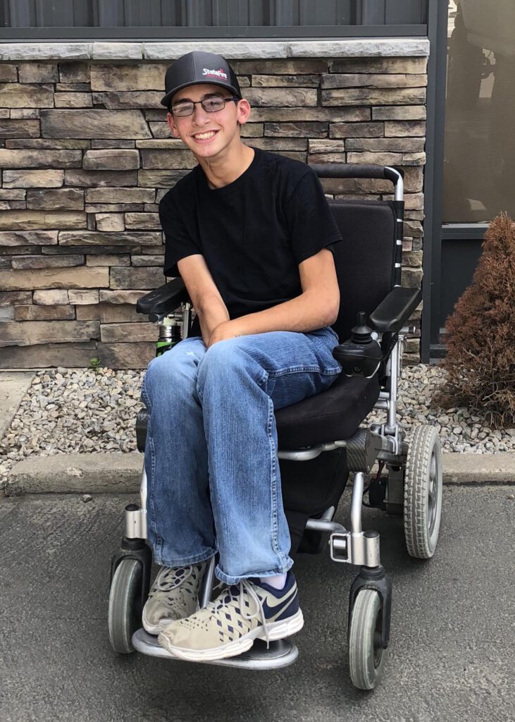 Dillon Maestrejuan sits in a wheelchair smiling