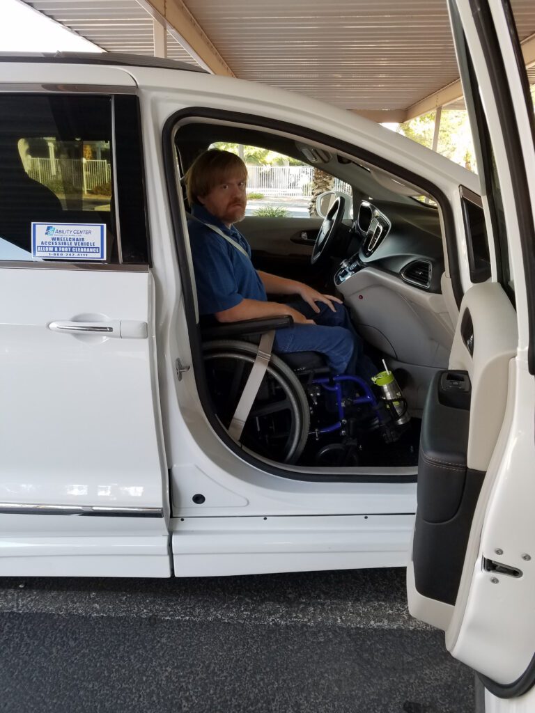 James Altman sits in a wheelchair in a van
