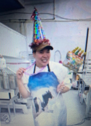 Michelle Lacayanga wears a party hat and apron