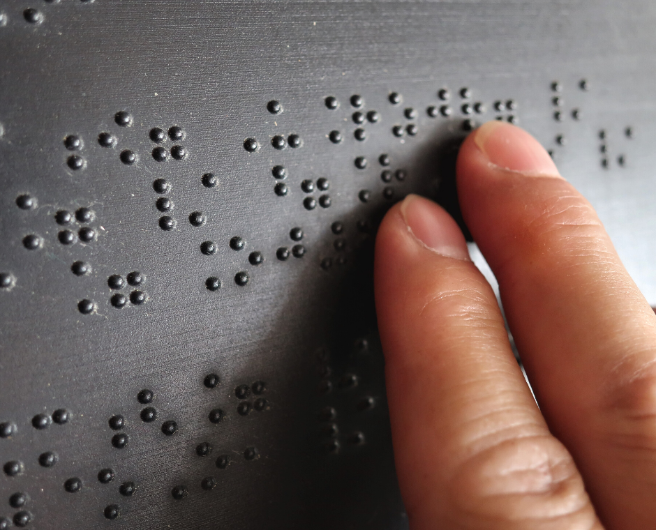 A woman's fingers read braille letters